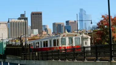 Boston Red Line train with skyline in background.